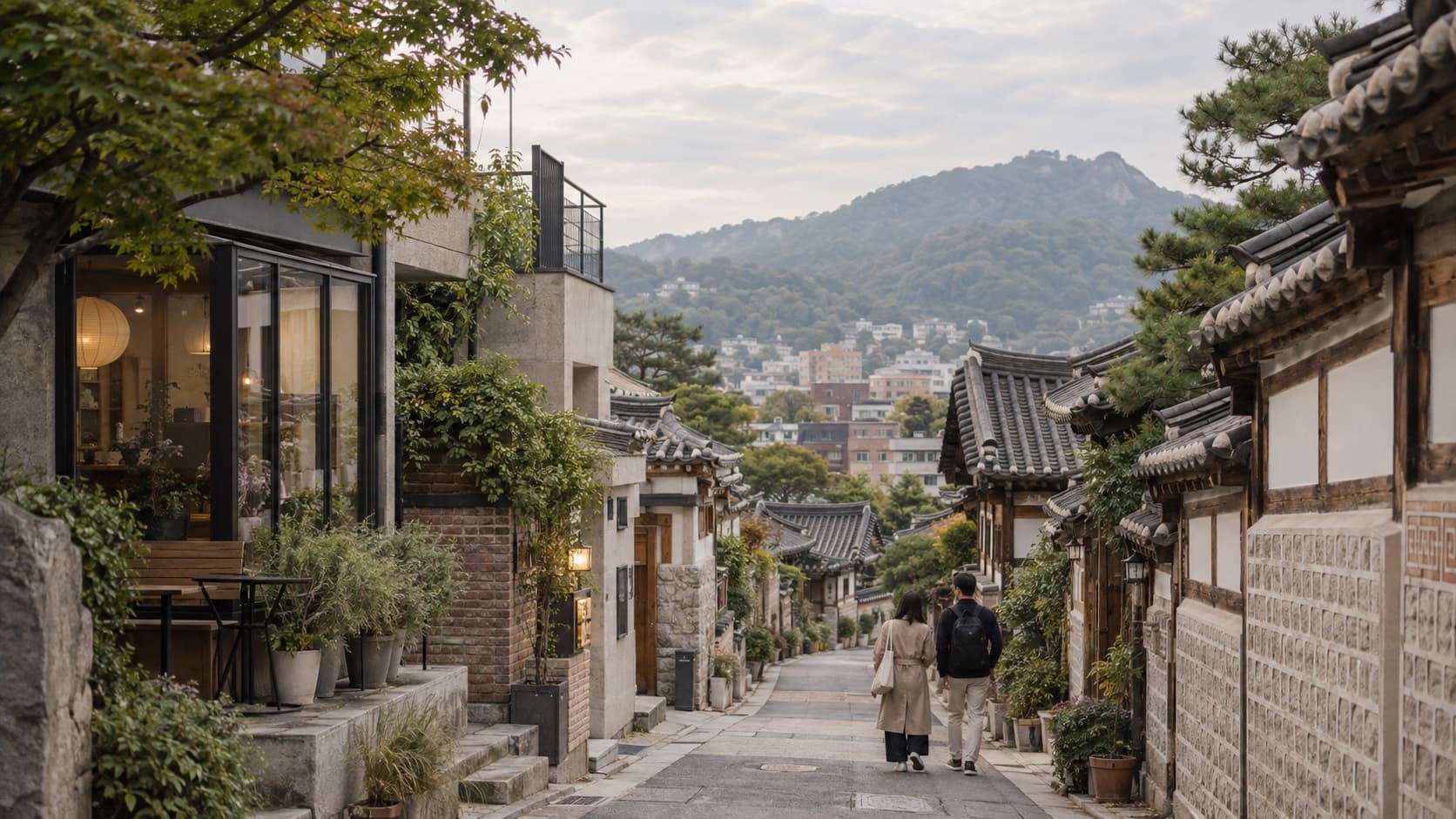 Two travelers walking through a quiet neighborhood in Seoul